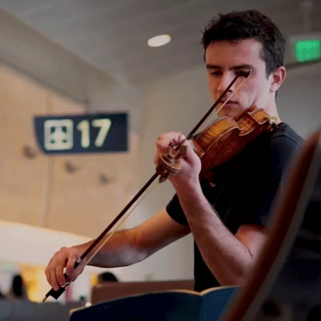 Ben and his violin at gate 17